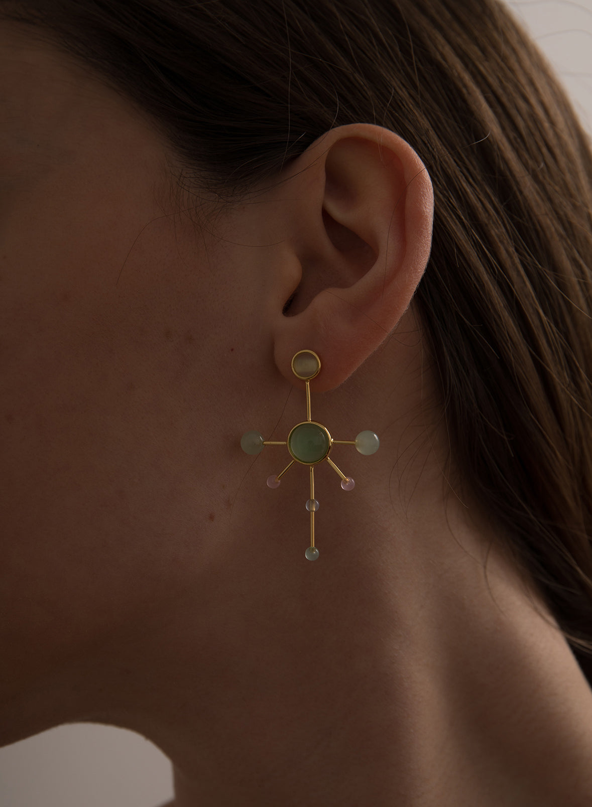 Original silver earrings with an asymmetrical design and colored stones.