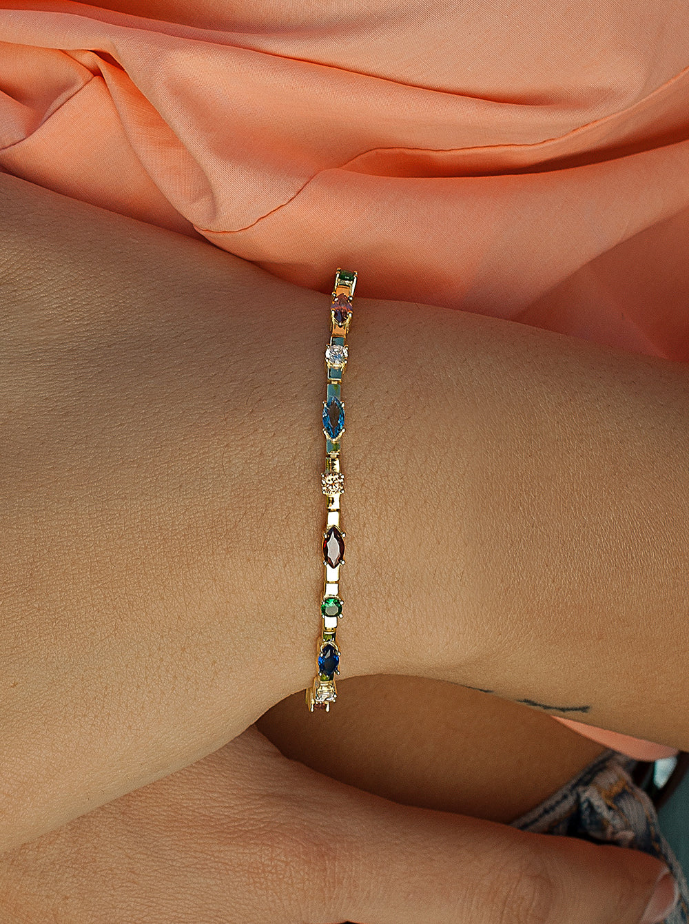 Bracelets with multicolored silver stones arranged linearly