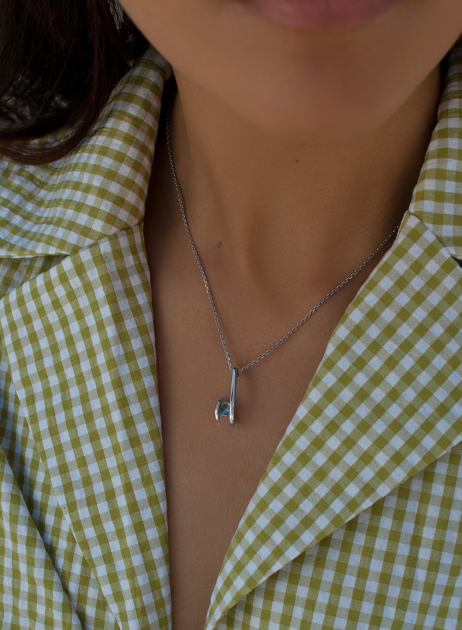 Original silver pendants with a zigzag design and a blue gemstone