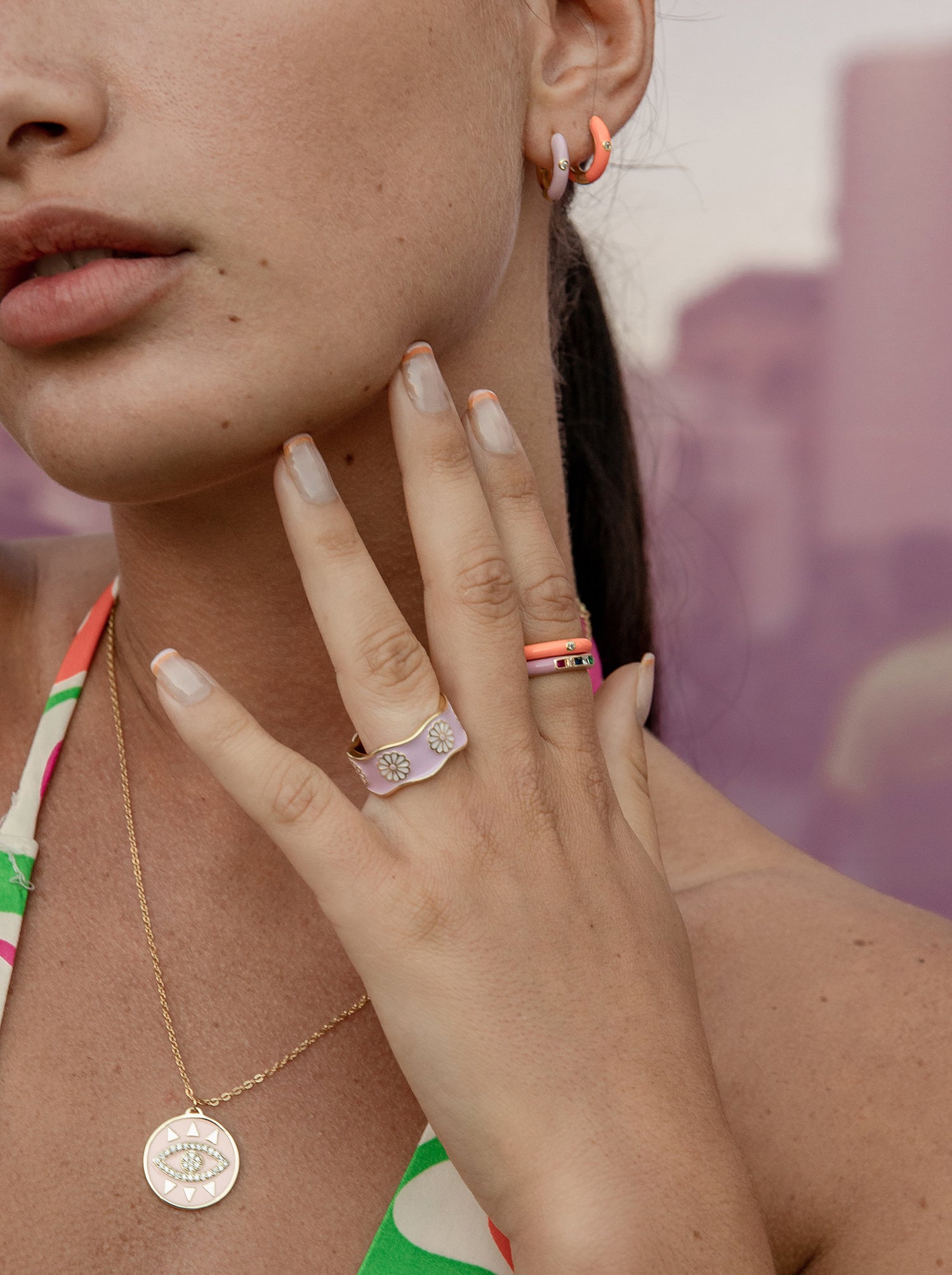 Orange enamel ring with a central cubic zirconia design, gold plated