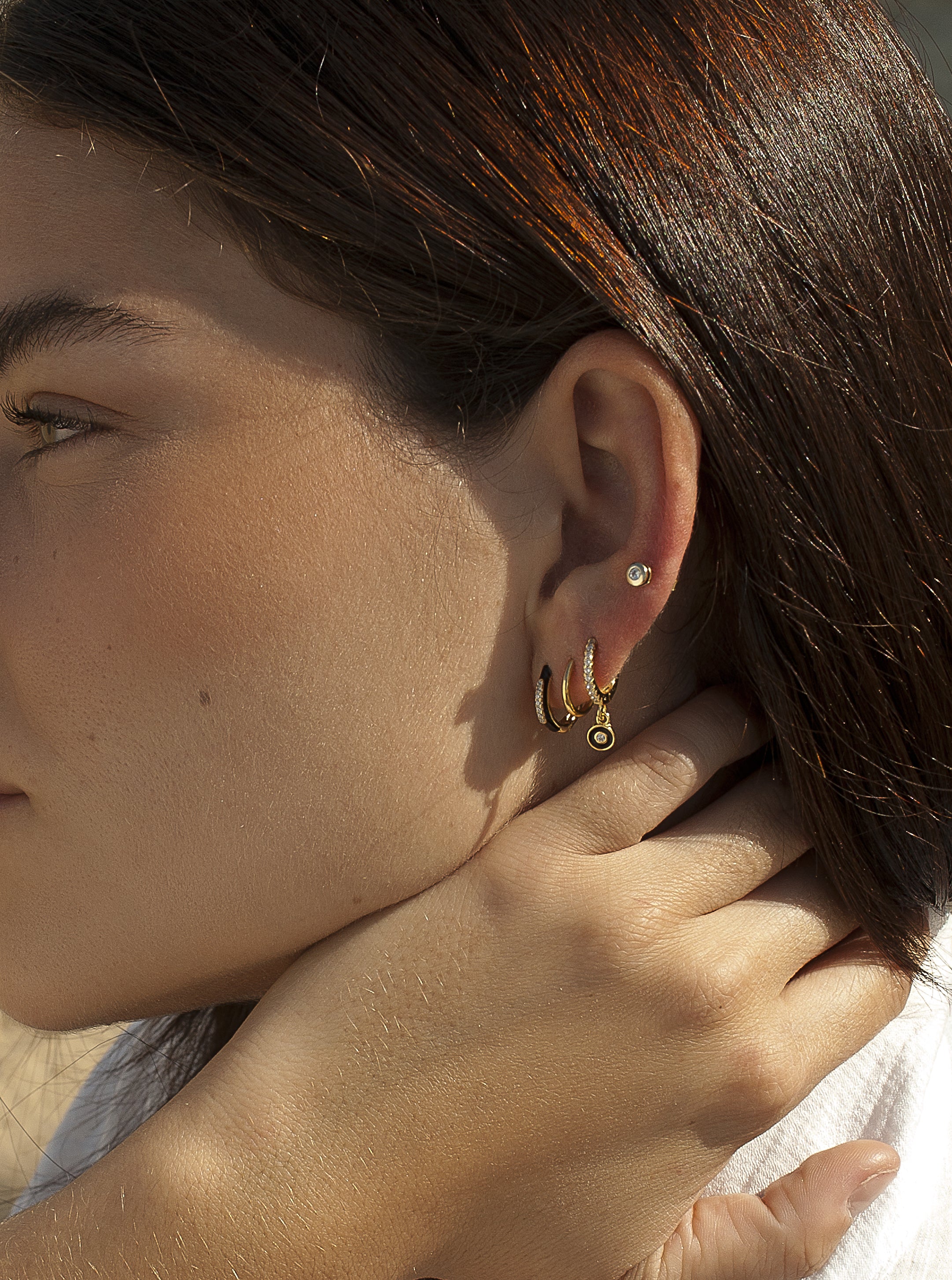 Black enamel small hoop earrings with central zirconia line
