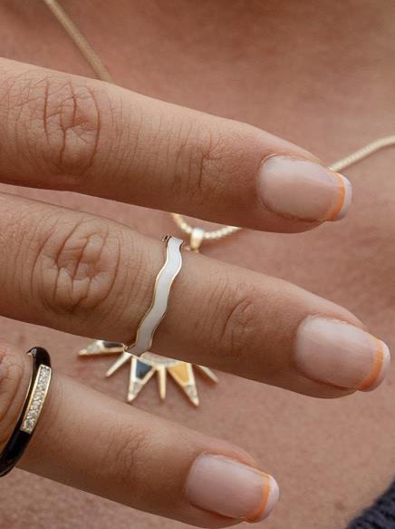 Thin silver rings with white enamel and curvilinear design