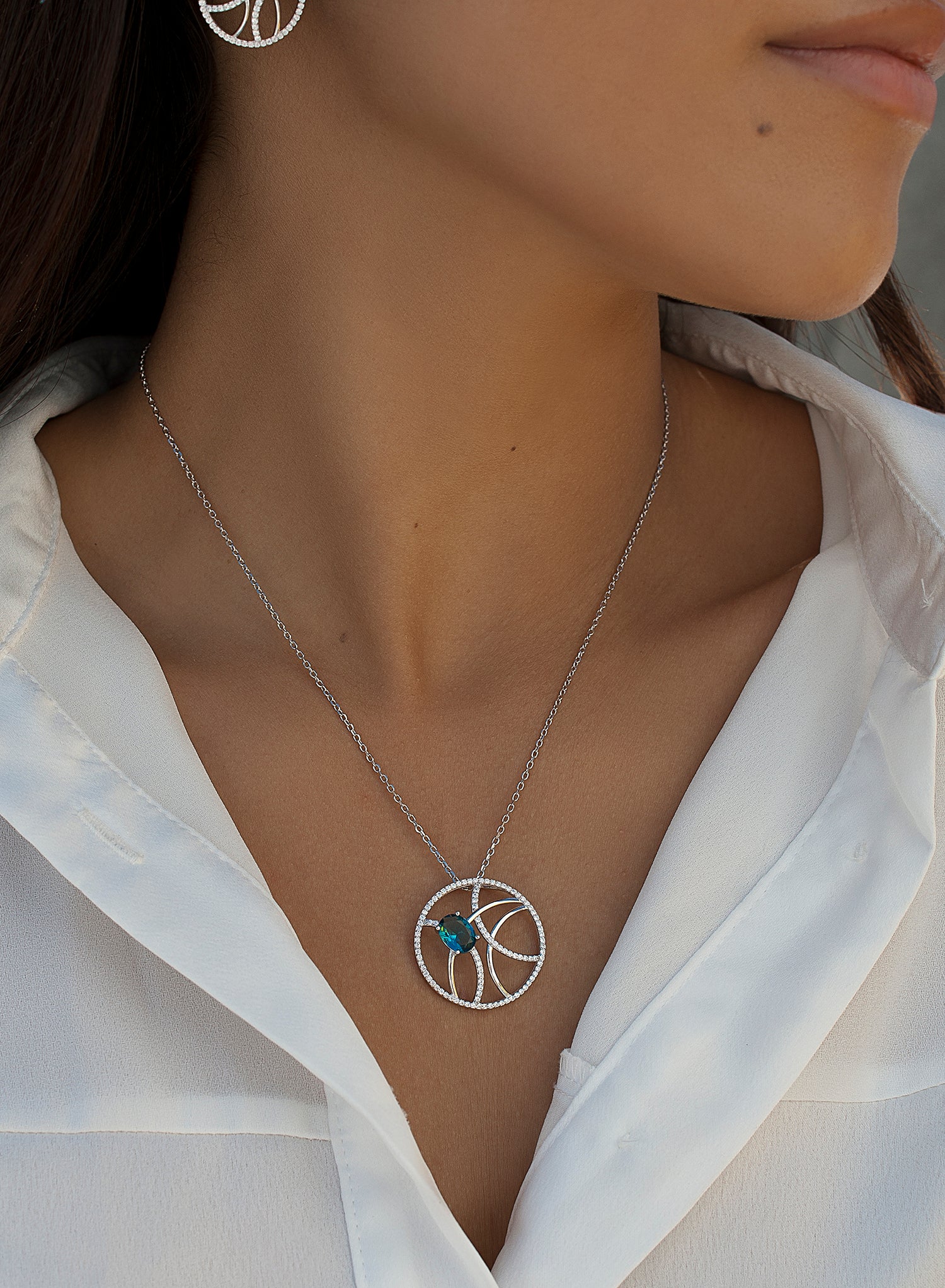 Large silver pendants with a circular aquamarine design