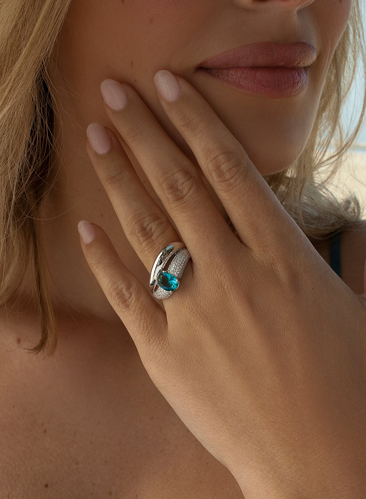 Curved design rings with aquamarine-toned gemstone