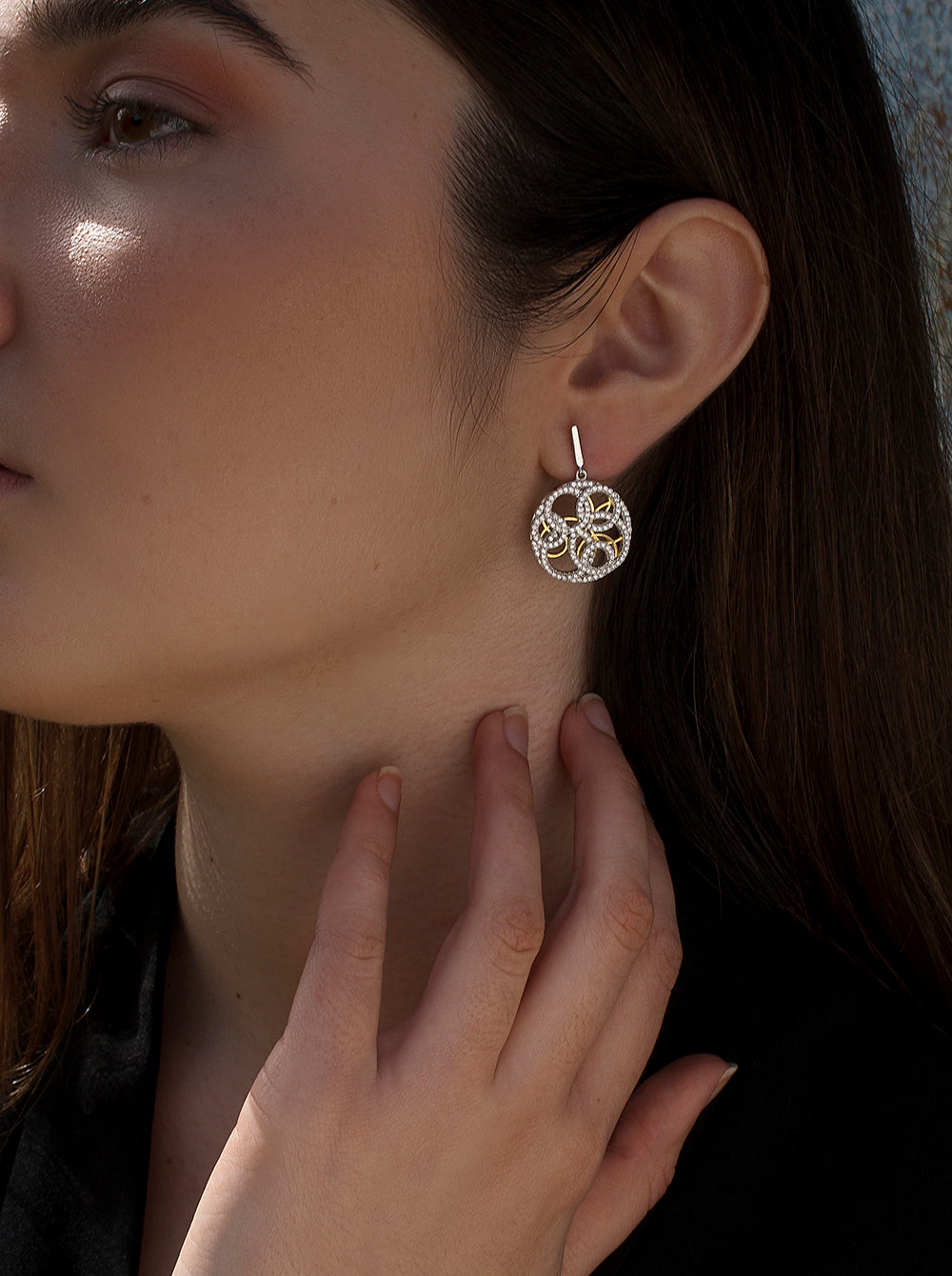 Two-tone earrings with an intertwined design and cubic zirconia
