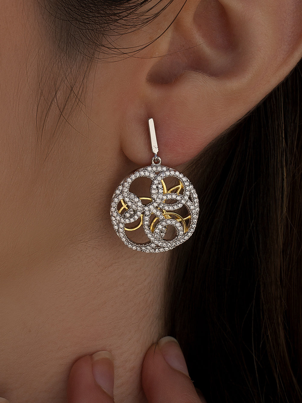 Two-tone earrings with an intertwined design and cubic zirconia