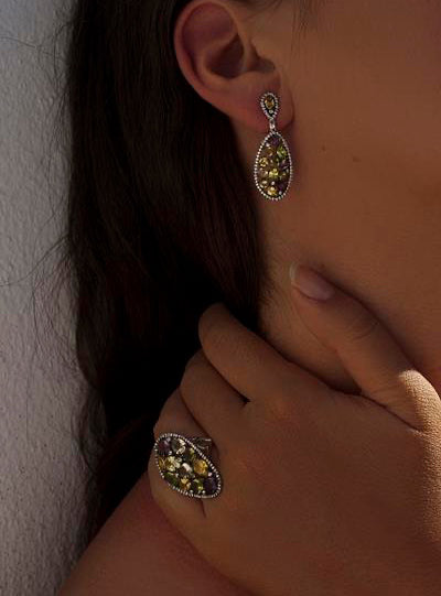 Rings with curvilinear style stones in green mosaic