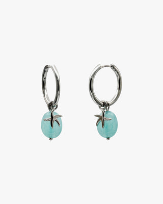 Boucles d'oreilles ornées de pendentifs en argent représentant des étoiles de mer et de la turquoise