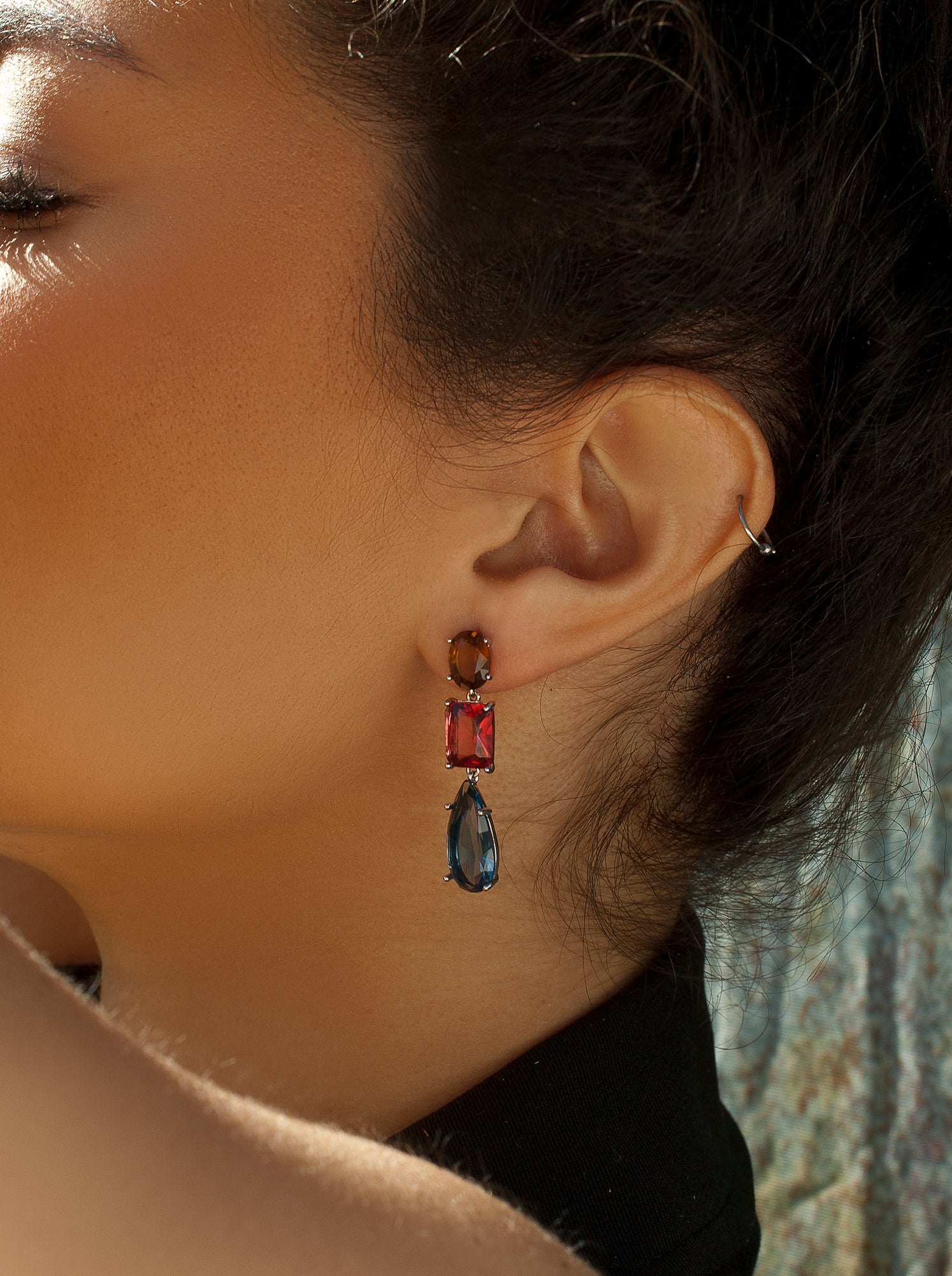 Silver earrings with colored stones in different sizes and shades