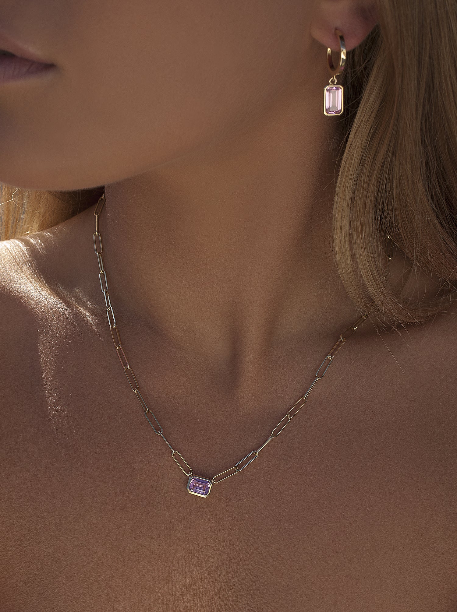Necklaces with pink stones and a gold link design