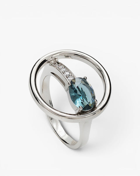 Circular design rings with a blue-toned gemstone