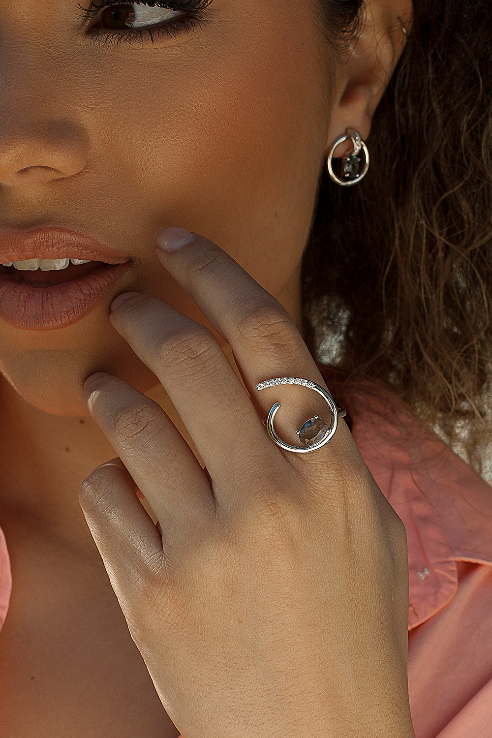 Semi-open design rings with central gemstone and zircons