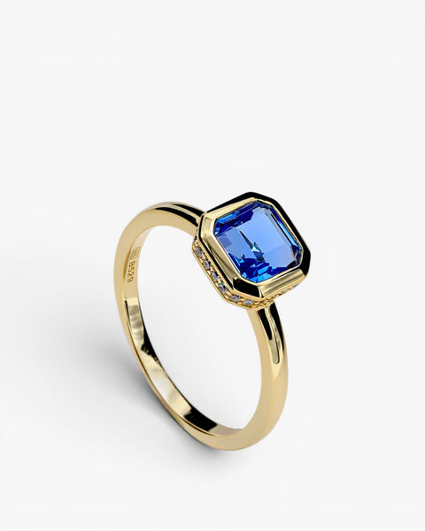 Rings with radiant cut sapphire-tone silver stones and cubic zirconia