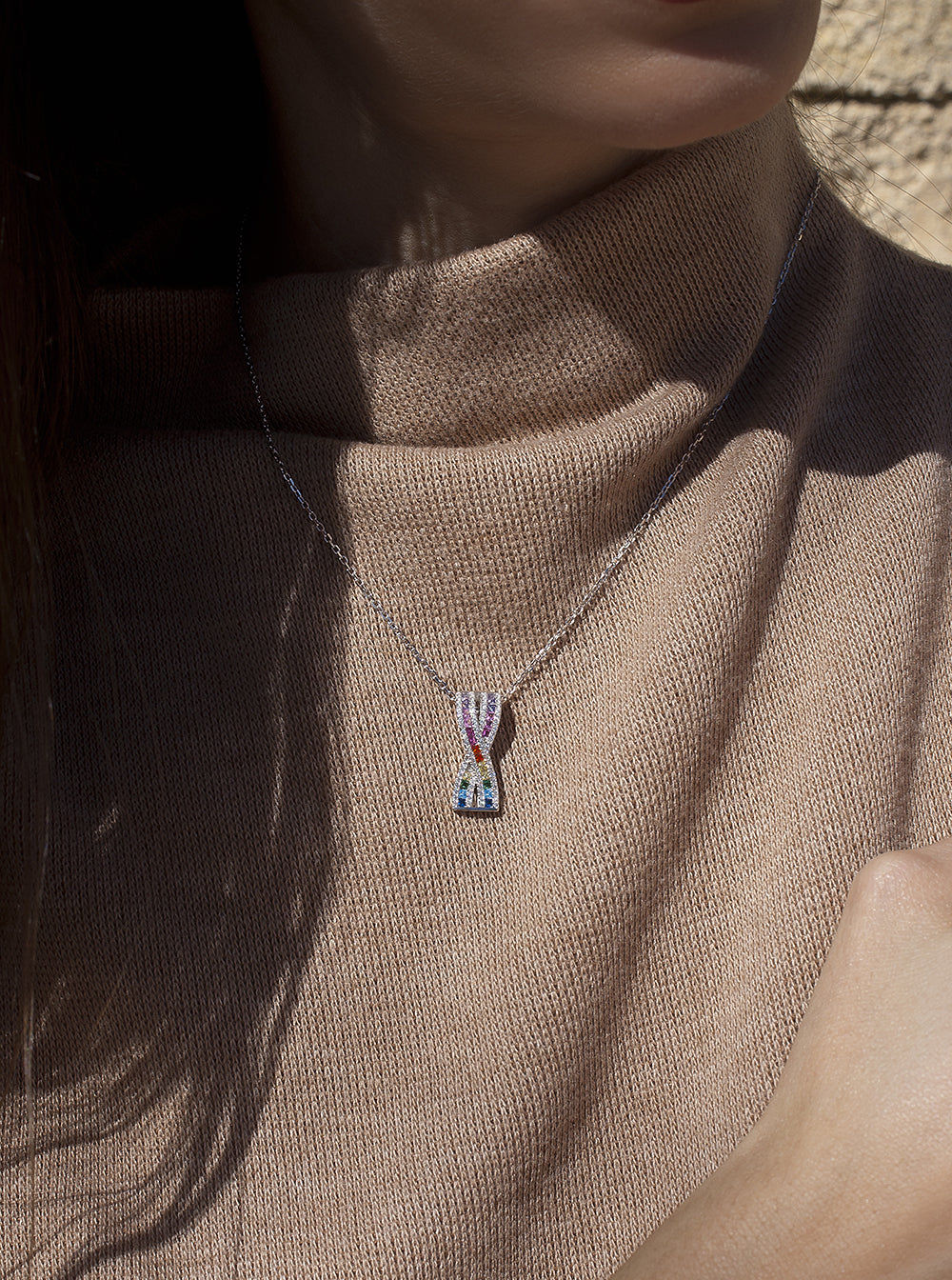 Necklaces with multicolored crossed rail design stones