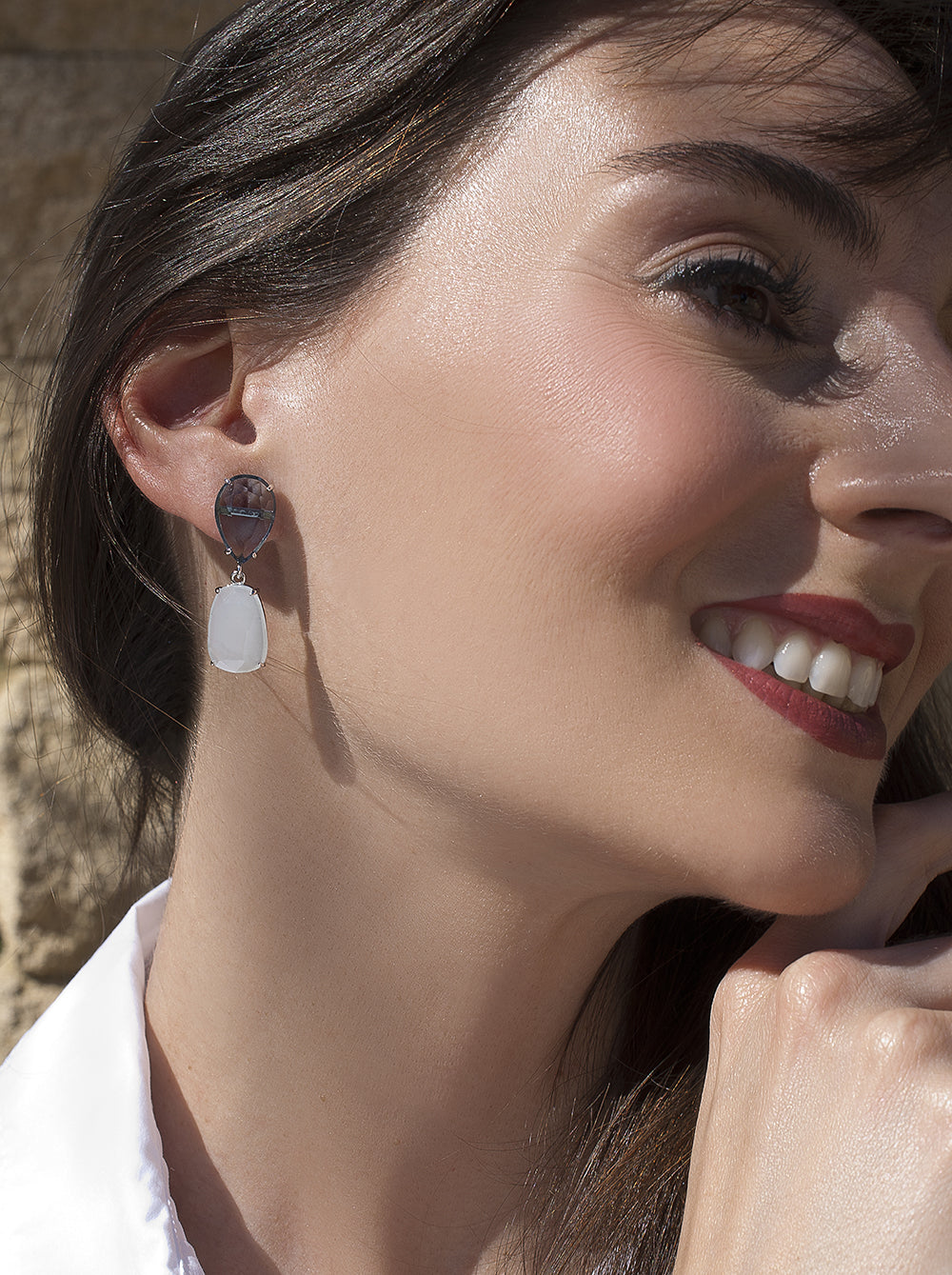 Earrings with colored stones in a milky blue tone