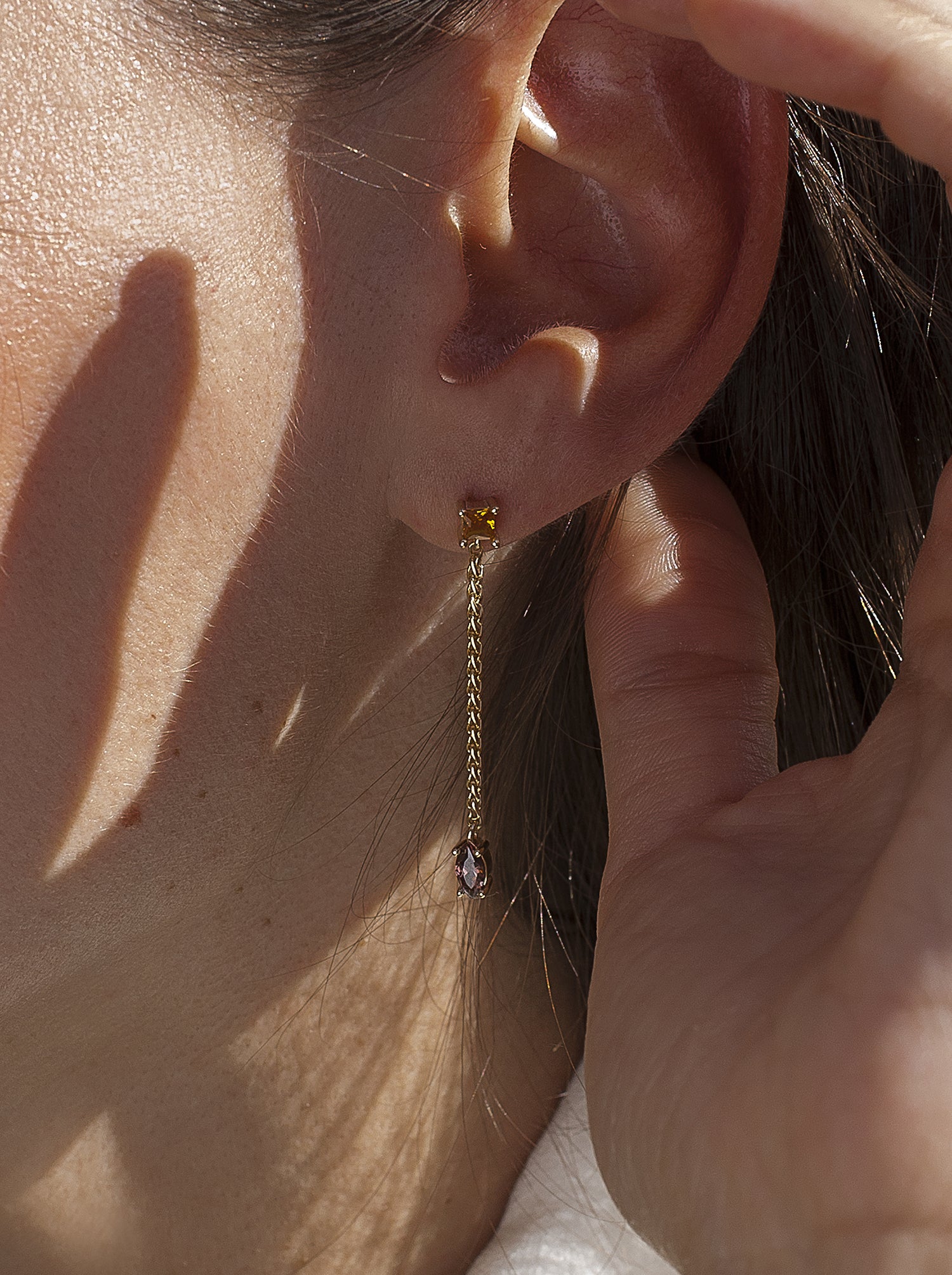Long silver earrings with chain design and multicolored gems