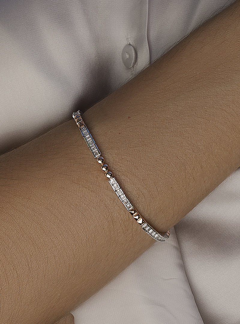 Two-tone riviere bracelet in rectangular pink with princess-cut cubic zirconia.