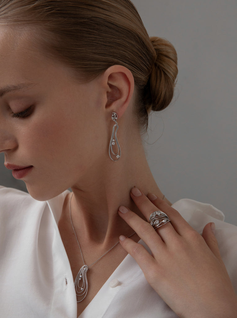 Long silver earrings with an organic design