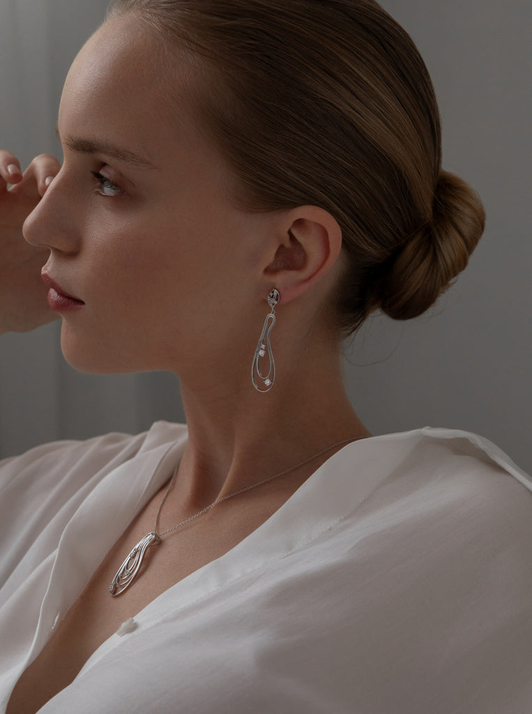 Long silver earrings with an organic design