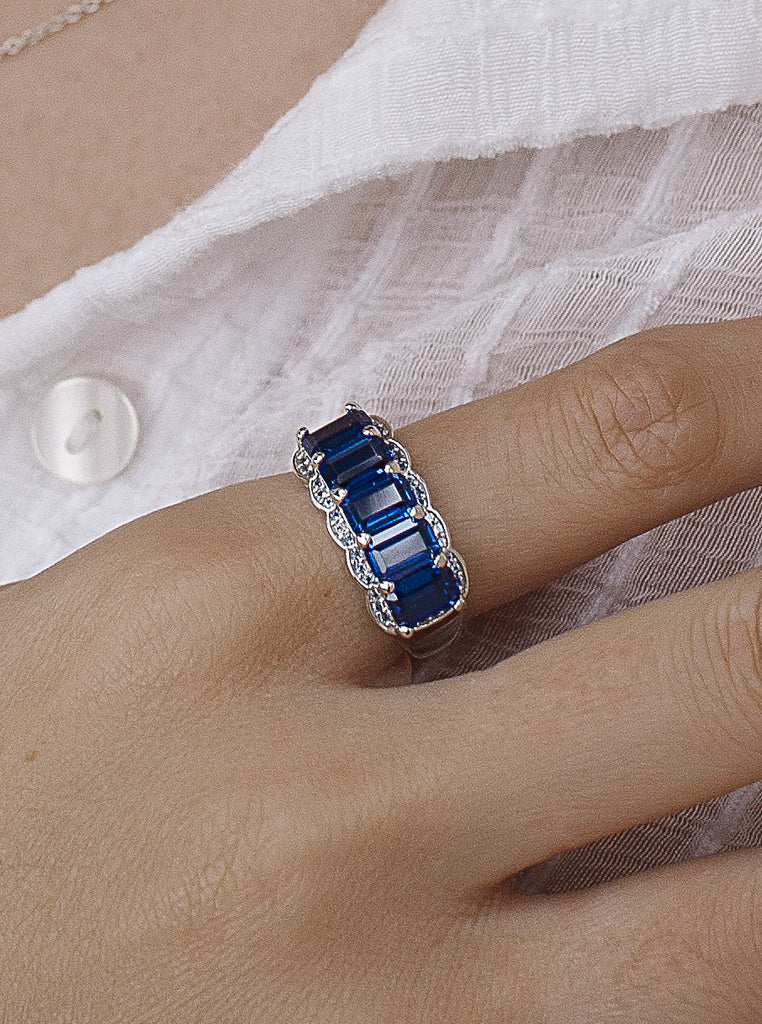 Rings with emerald-cut stones in an azurite tone