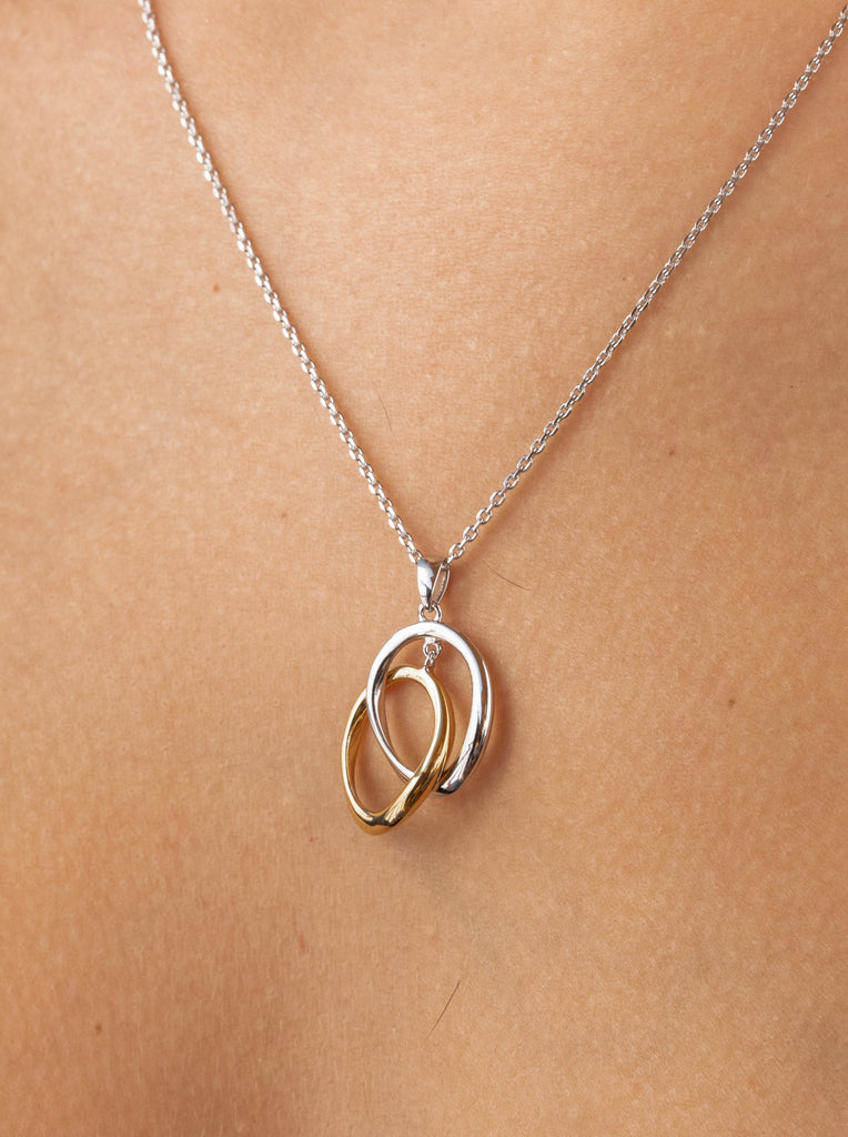 Two-tone silver pendant with intertwined rings