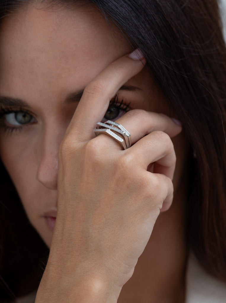 Wide ring with geometric shapes of cubic zirconia