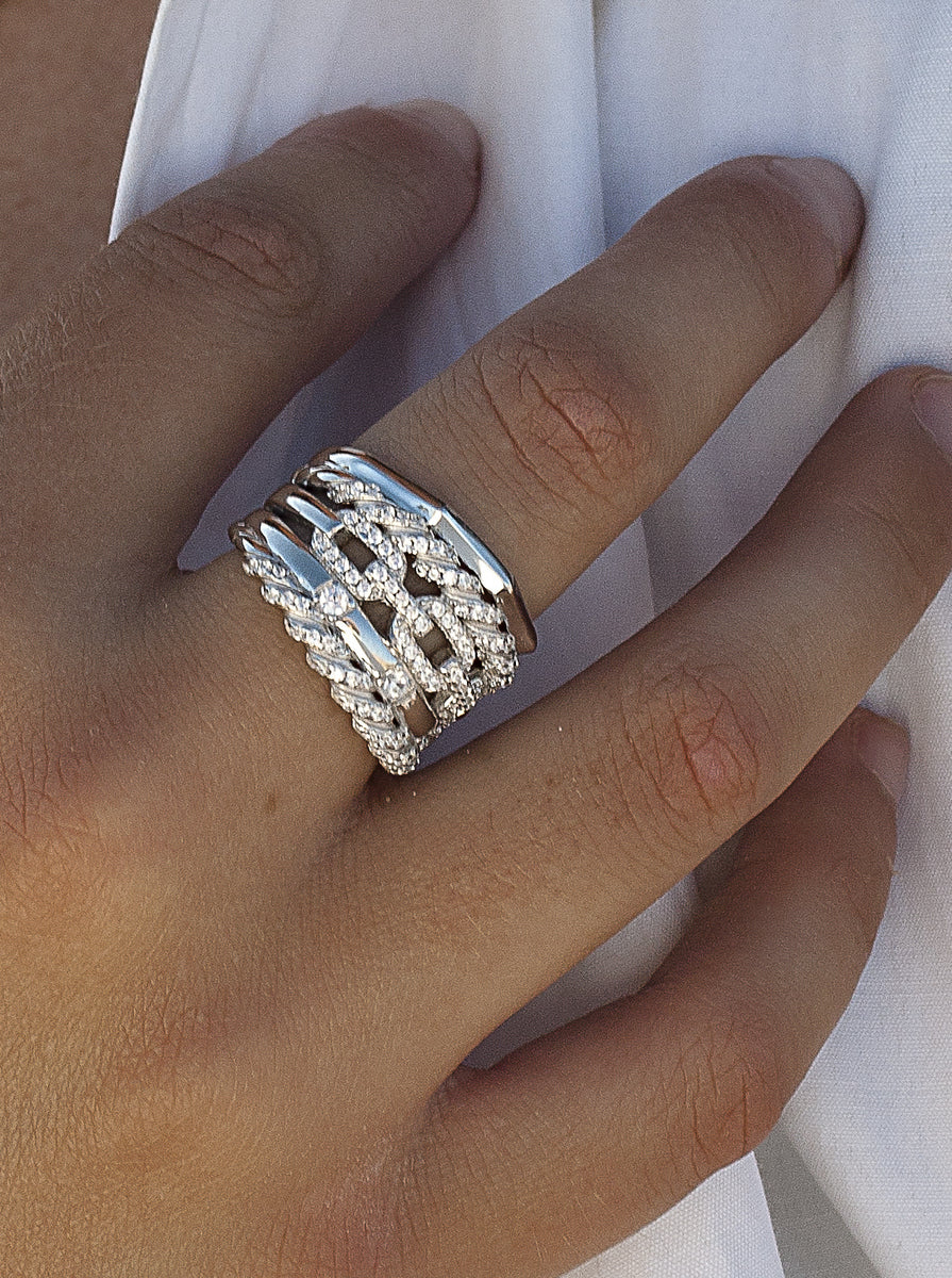 Anillo ancho de plata con circonitas y diseño entrelazado