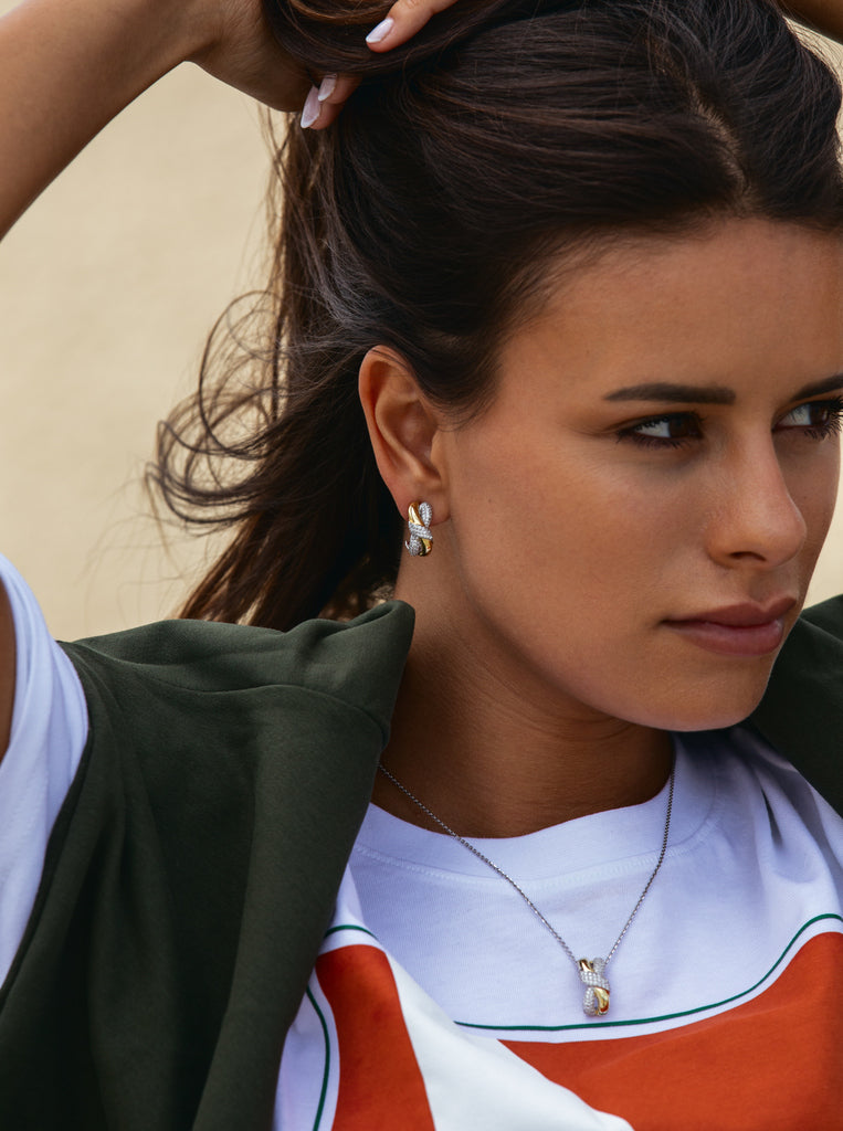 Two-tone earrings linked with a knot and cubic zirconia