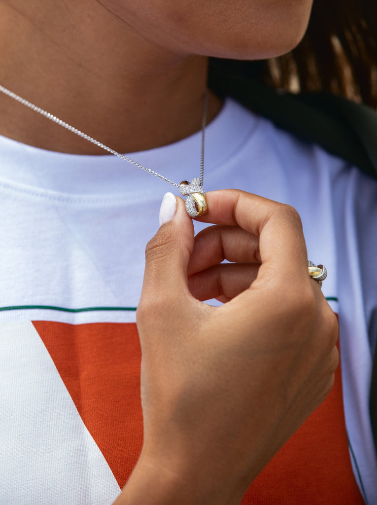 Two-tone necklace linked with a knot and cubic zirconia