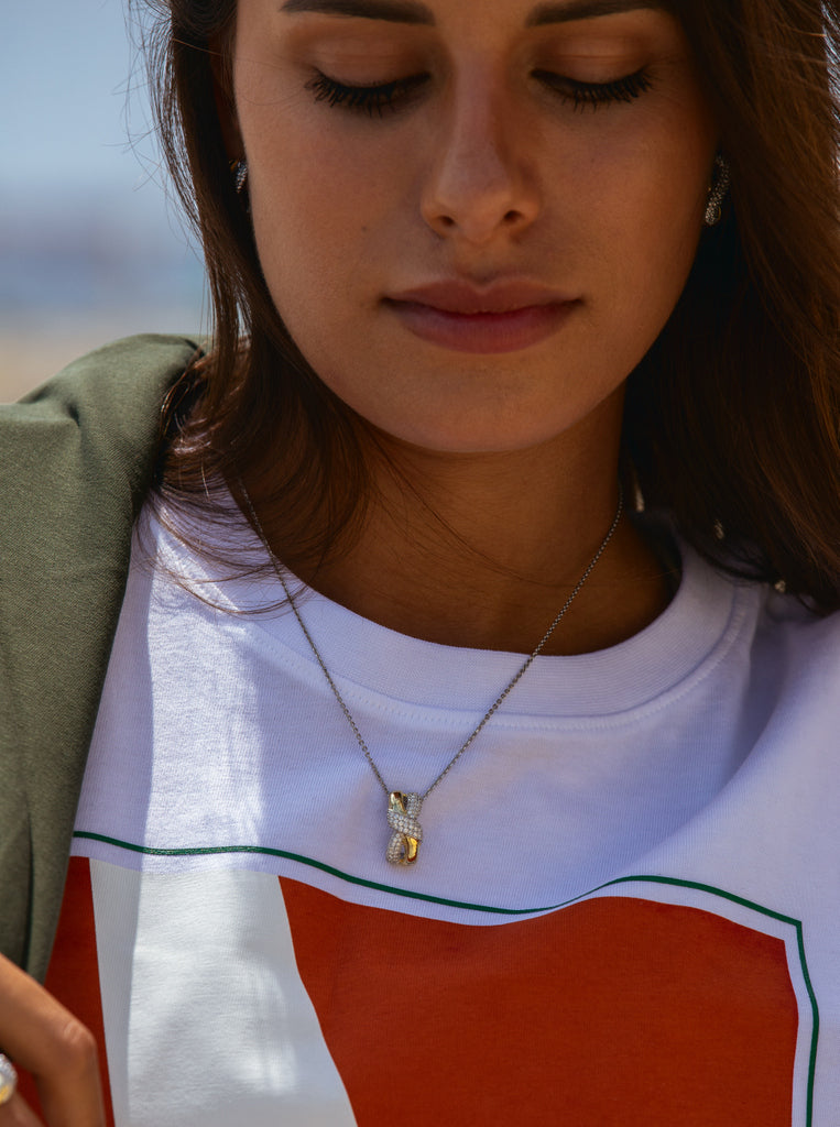 Two-tone necklace linked with a knot and cubic zirconia