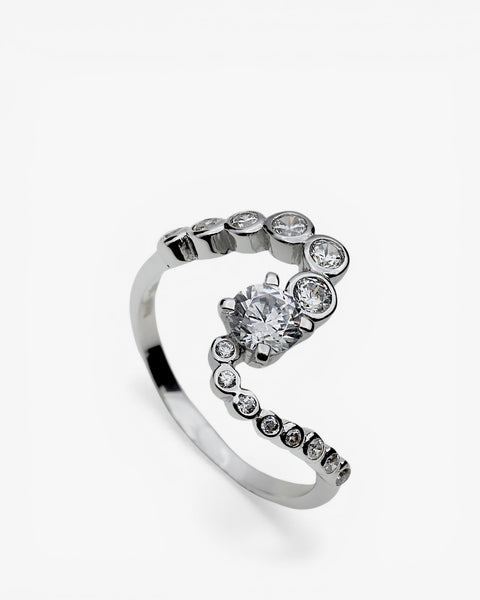 Wavy silver ring with cubic zirconia stones of different sizes around its perimeter