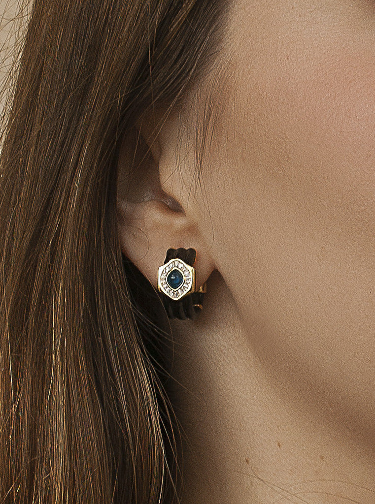 Silver hoop earrings with black enamel and blue stone