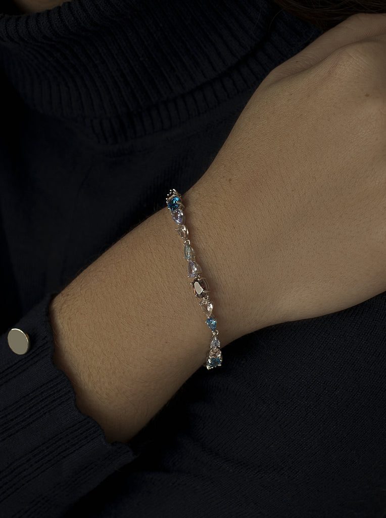 silver bracelet with stones in shades of blue and pink