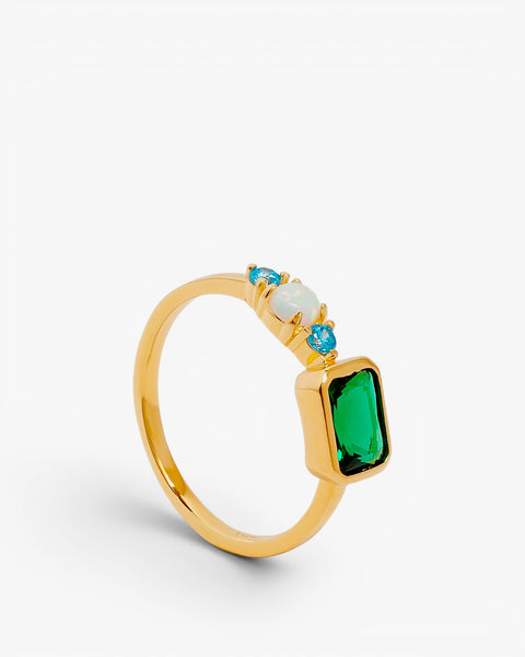 Silver ring with opal, blue stones, and a rectangular green stone