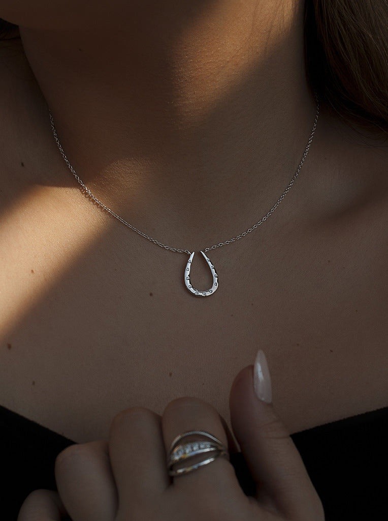 Silver necklace with horseshoe-shaped cubic zirconia