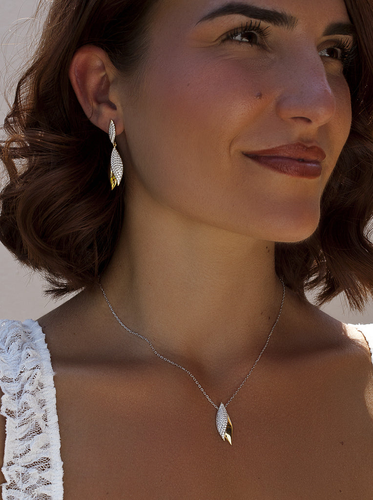 Two-tone silver earrings with cubic zirconia leaf design