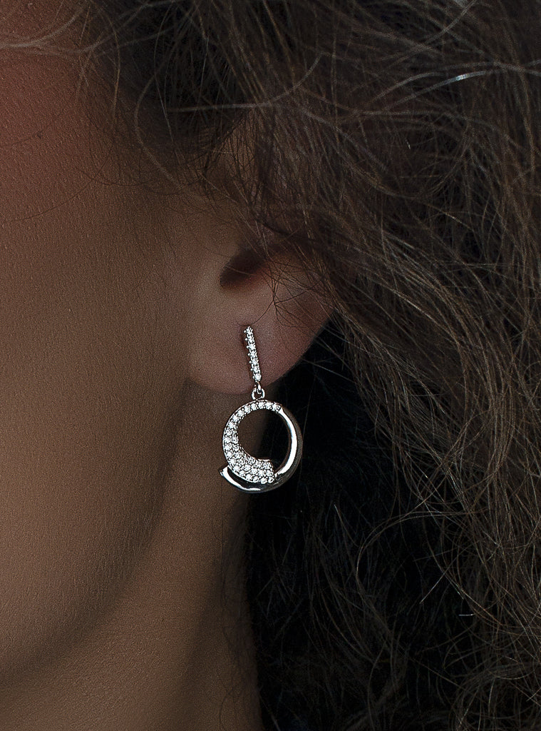 Silver dangle earrings with circular design cubic zirconia