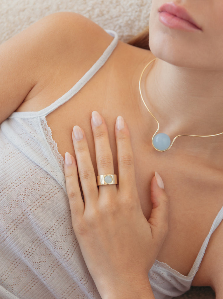 Wide gold-plated silver ring with a cabochon blue stone