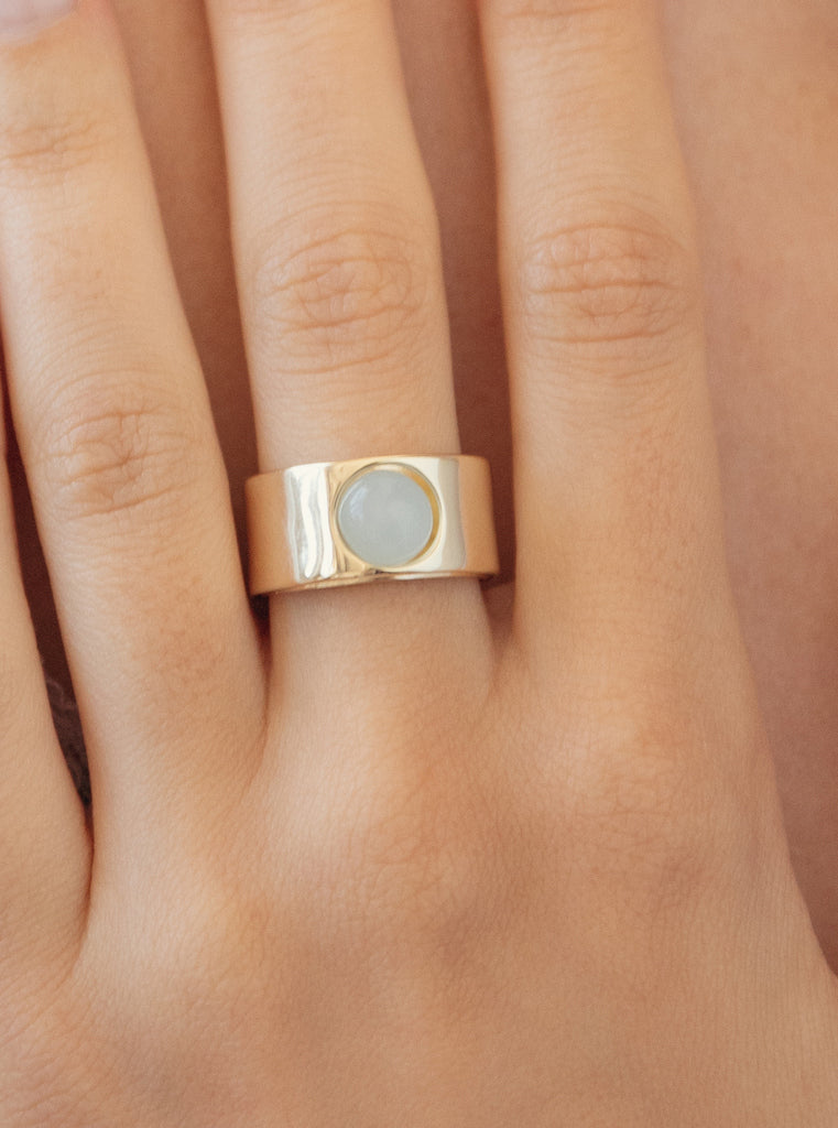 Wide gold-plated silver ring with a cabochon blue stone