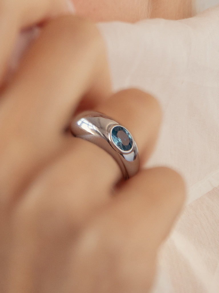 Silver ring with organic design and blue gem