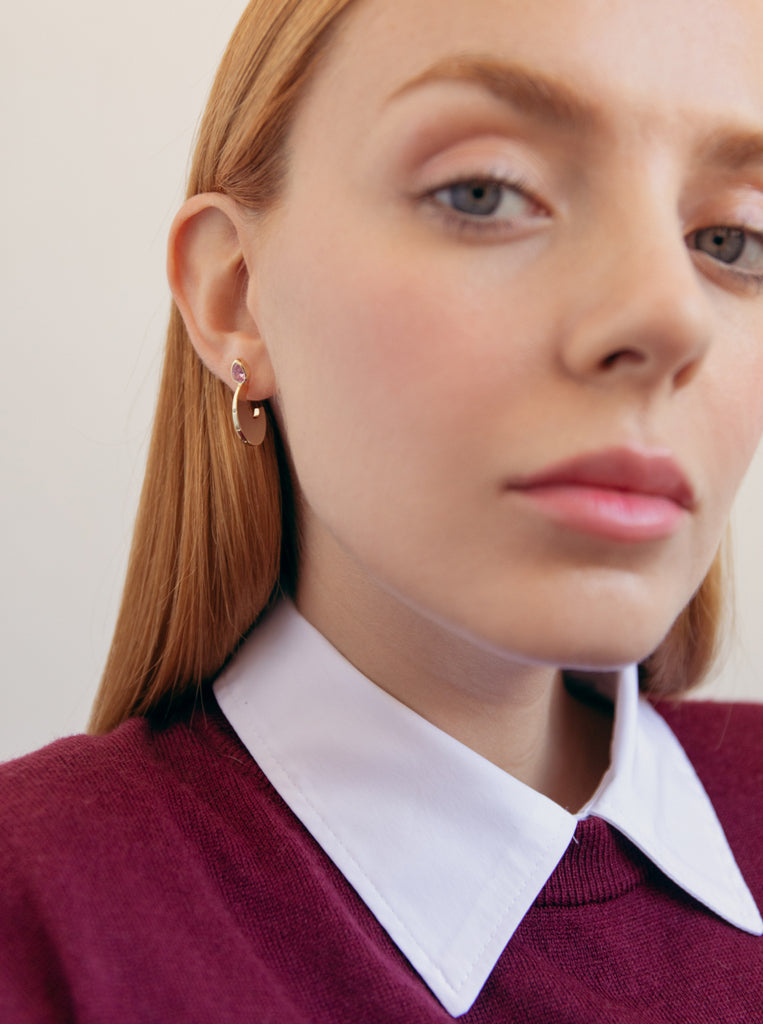 Silver earrings with gold plating, a pink drop-shaped stone, and cubic zirconia