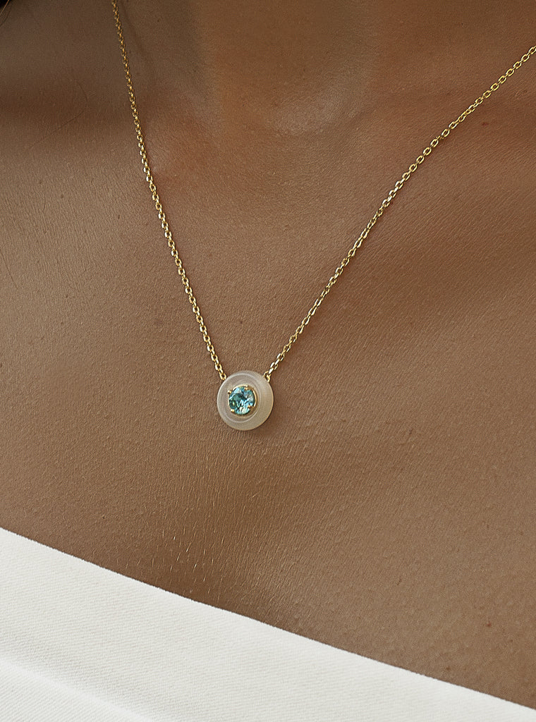 Gold necklace with mother-of-pearl and turquoise disc pendant