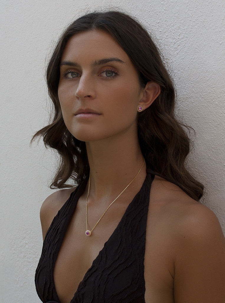 Gold necklace with pink disc pendant and fuchsia zirconia