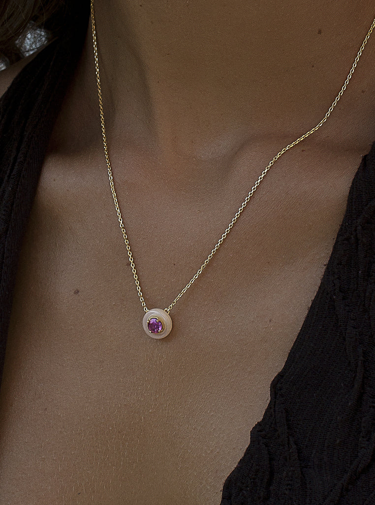 Gold necklace with pink disc pendant and fuchsia zirconia