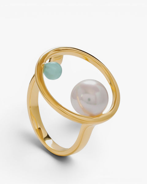 Gold ring with pearl and green stone circle design