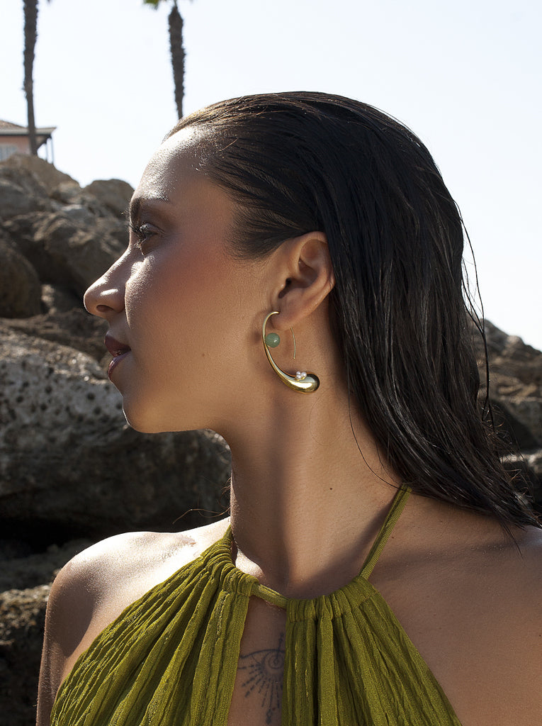 Pendientes curvos dorados con perlas y piedra verde