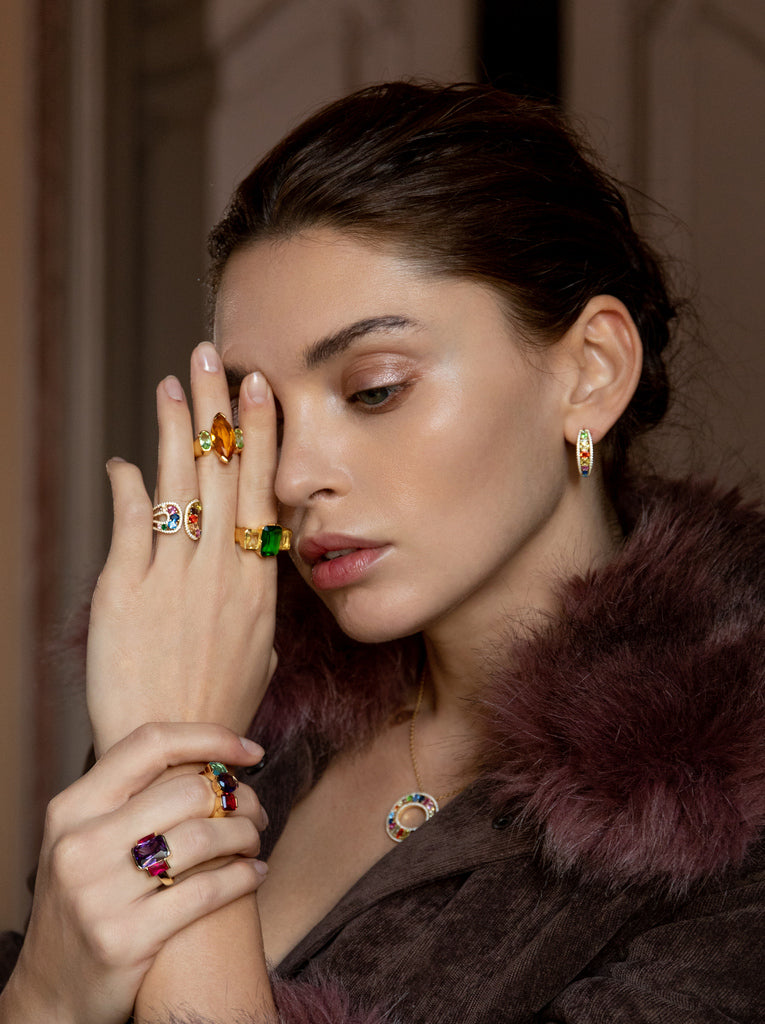 Anillo de plata bañado en oro con piedras verde esmeralda y champagne