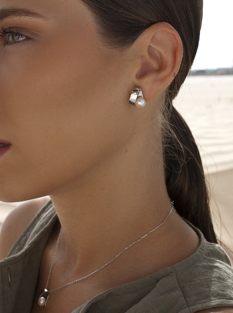 Sterling silver earrings with pearl and wraparound geometric design