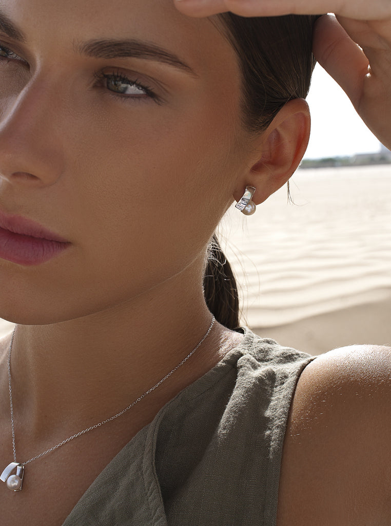 Sterling silver earrings with pearl and wraparound geometric design
