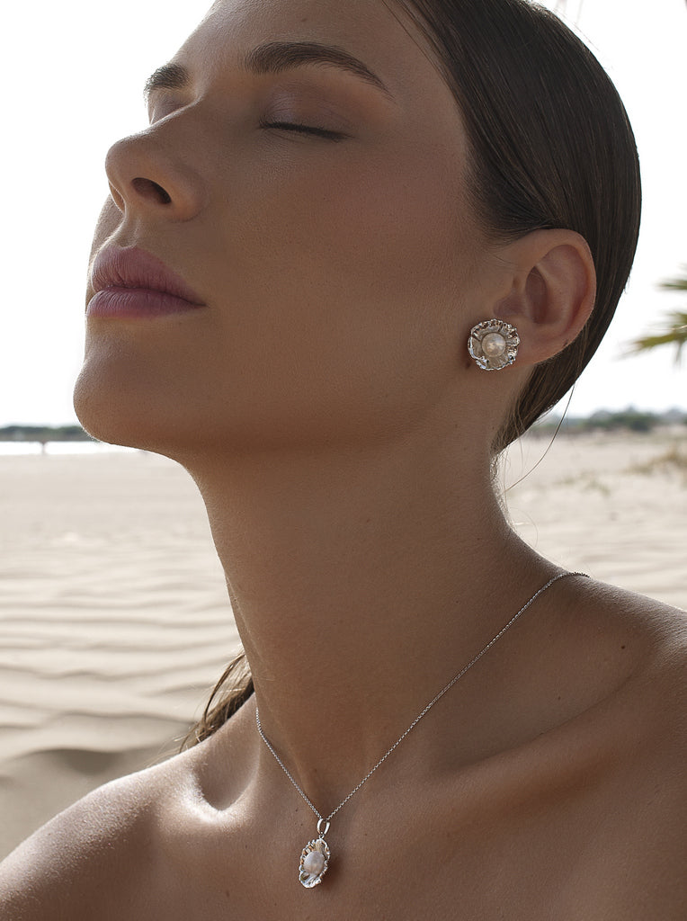 Silver flower earrings with a central pearl